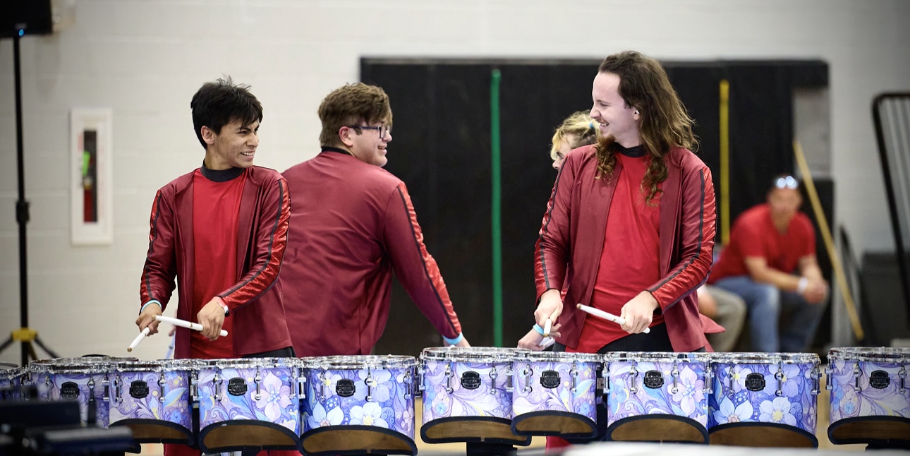 Image of Lex in Uniform drumming with friends